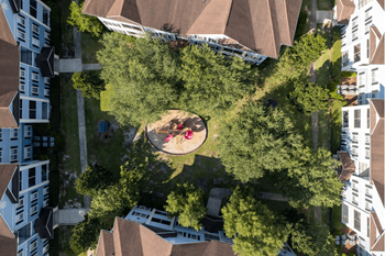 A birdseye view of a park with people sitting on the grass